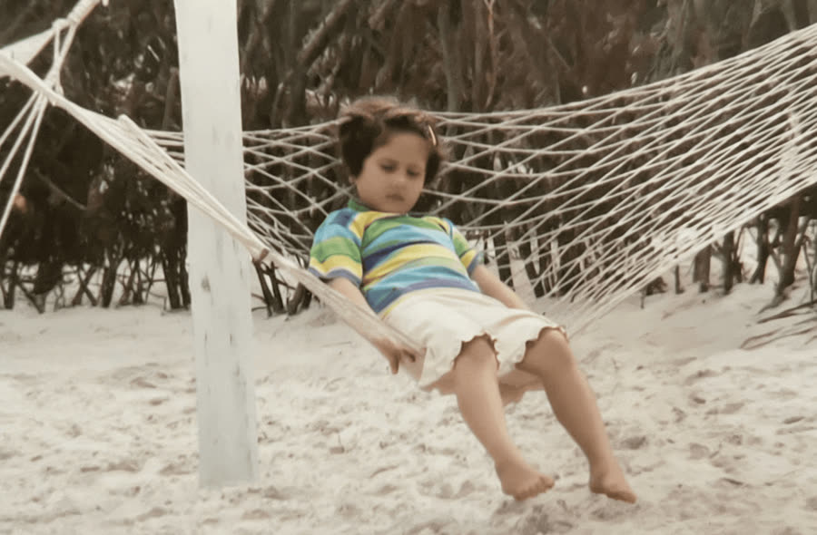Natalia as a kid, lounging in a hammock